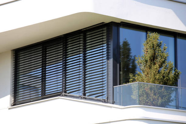 Modern home exterior with black horizontal window blinds on large corner windows in Kitchener-Waterloo, Ontario.