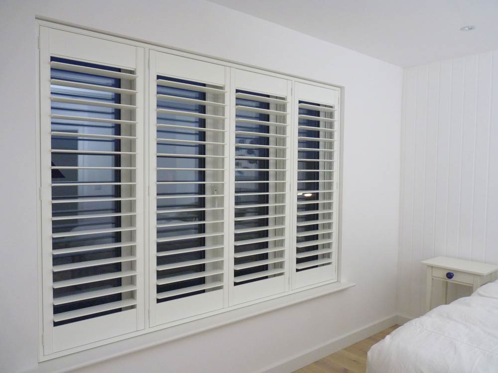 White plantation shutters installed on bedroom windows in a modern Milton home.